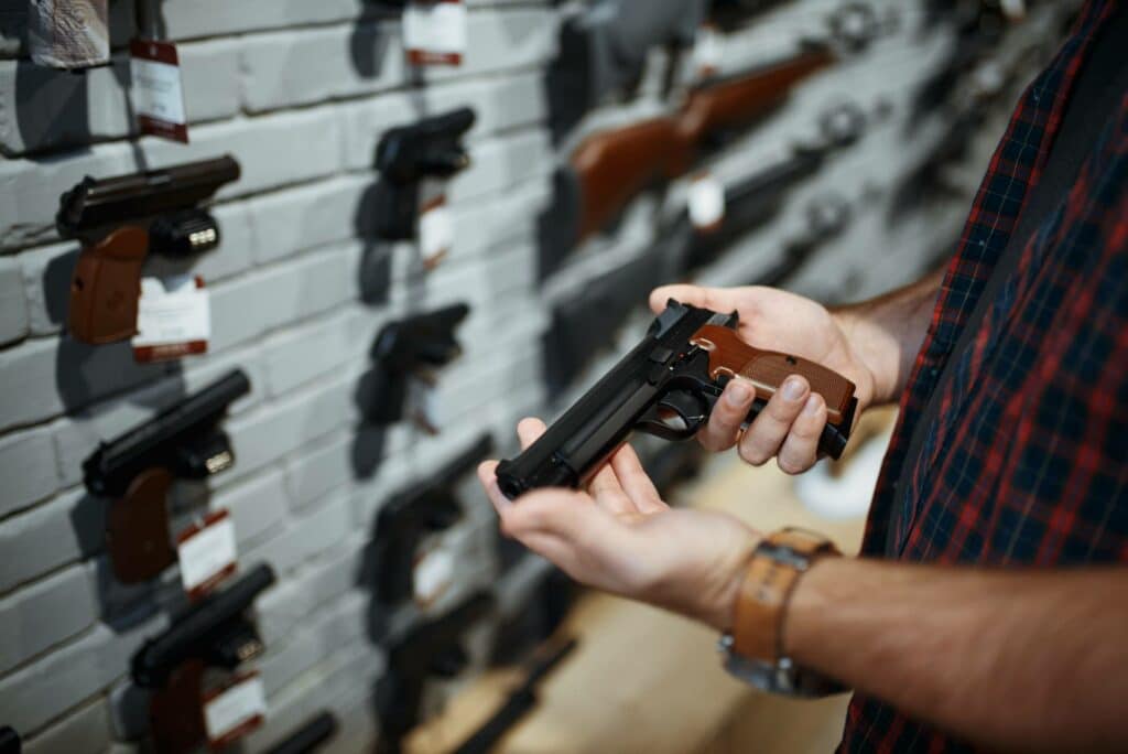 Man-holds-handgun-in-gun-shop